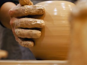 Potter is making clay pot bowl or vase ceramics porcelain on the potter's wheel. Creating pottery art and handicraft modelling creation.