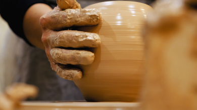 Potter is making clay pot bowl or vase ceramics porcelain on the potter's wheel. Creating pottery art and handicraft modelling creation.